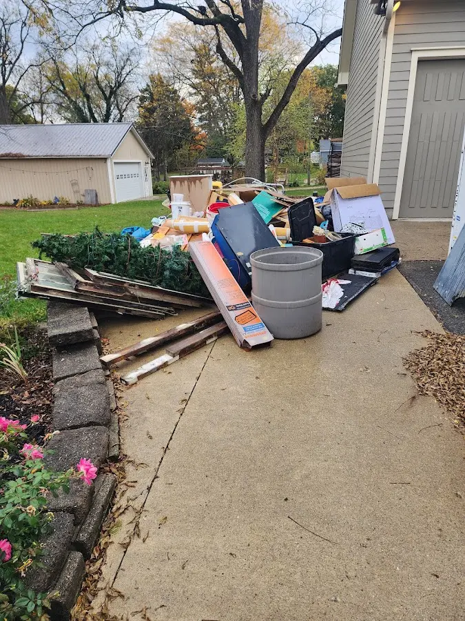 Dumpster being loaded with debris for 10 Yard Dumpster Rental in Plover